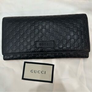 Gucci Black Embossed Wallet.